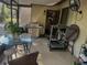 Enclosed patio featuring a glass top table, stainless steel grill, and various exercise equipment at 466 Club Dr, Winter Springs, FL 32708