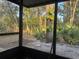 Screened-in patio with views of lush greenery and an outdoor living space at 466 Club Dr, Winter Springs, FL 32708