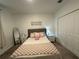 Cozy bedroom featuring a comfortable bed, two nightstands, neutral wall decor and mirrored standing cabinet at 4740 Tribute Trl, Kissimmee, FL 34746