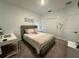 Cozy bedroom features neutral colors, plush carpet, and a comfortable bed with stylish headboard at 4740 Tribute Trl, Kissimmee, FL 34746