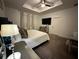 Spacious primary bedroom features tray ceiling, ceiling fan, and stylish decor at 4740 Tribute Trl, Kissimmee, FL 34746