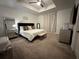 Cozy bedroom with neutral carpet, ceiling fan, and stylish décor, creating a relaxing ambiance at 4740 Tribute Trl, Kissimmee, FL 34746