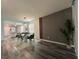 Open-concept dining area adjacent to the living room, featuring modern furniture, hardwood floors and natural light at 4740 Tribute Trl, Kissimmee, FL 34746