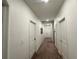 Hallway features carpet flooring and white trim, with multiple doors leading to various rooms at 4740 Tribute Trl, Kissimmee, FL 34746
