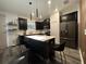 Modern kitchen with stainless steel appliances, a central island, and sleek black cabinetry at 4740 Tribute Trl, Kissimmee, FL 34746