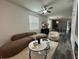 Chic living room boasts modern furniture, hardwood floors, and stylish decor, complemented by abundant natural light at 4740 Tribute Trl, Kissimmee, FL 34746