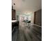 Open-concept living space with wood floors, contemporary decor, and a dining area at 4740 Tribute Trl, Kissimmee, FL 34746
