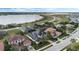 View of neighborhood homes with solar panels near a lake and conservation area at 4959 Tennessee Lake Dr, Auburndale, FL 33823