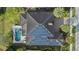 Aerial view of house featuring backyard pool and solar panels on roof at 4959 Tennessee Lake Dr, Auburndale, FL 33823