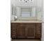 Bathroom features a dark wood vanity with light countertops and a large framed mirror at 4959 Tennessee Lake Dr, Auburndale, FL 33823