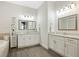 Bathroom features double sinks, granite countertops, and framed mirrors at 4959 Tennessee Lake Dr, Auburndale, FL 33823