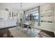 Bright dining room boasts stylish decor, natural light, and an elegant chandelier at 4959 Tennessee Lake Dr, Auburndale, FL 33823