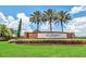 The Lake Juliana Estates sign is surrounded by greenery and palm trees on a sunny day at 4959 Tennessee Lake Dr, Auburndale, FL 33823
