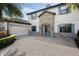 Home showcasing a white facade, blue shutters, stone accents, and a paver driveway at 4959 Tennessee Lake Dr, Auburndale, FL 33823