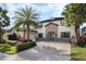 Gorgeous two-story home with stone accents, paver driveway, and meticulously landscaped yard at 4959 Tennessee Lake Dr, Auburndale, FL 33823