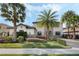 Charming two-story home with tropical landscaping, stone accents, and a paver driveway at 4959 Tennessee Lake Dr, Auburndale, FL 33823