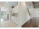 Bright foyer with hardwood floors, white cabinetry, and arched entryway leading into the main living space at 4959 Tennessee Lake Dr, Auburndale, FL 33823