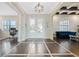 Inviting foyer with tile-trimmed wood floors, decorative lighting, and open living spaces at 4959 Tennessee Lake Dr, Auburndale, FL 33823
