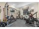 At-home gym featuring free weights and cardio machines with a flat-screen television and accent brick wall at 4959 Tennessee Lake Dr, Auburndale, FL 33823