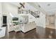 Spacious living room with dark wood floors, large windows, and stairway at 4959 Tennessee Lake Dr, Auburndale, FL 33823