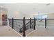 Spacious loft with black iron railing overlooking downstairs, offering a bright and open feel at 4959 Tennessee Lake Dr, Auburndale, FL 33823