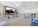 Carpeted loft featuring a large screen, comfortable seating, and stylish decor at 4959 Tennessee Lake Dr, Auburndale, FL 33823