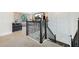 Loft area with dark wood and black iron railing overlooking a home theater with a large screen at 4959 Tennessee Lake Dr, Auburndale, FL 33823