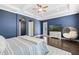Tranquil main bedroom with hardwood floors, tray ceilings, a decorative chair and a view to the backyard at 4959 Tennessee Lake Dr, Auburndale, FL 33823