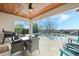 Outdoor patio with dining table, grill, and view of infinity pool, backyard and neighborhood at 4959 Tennessee Lake Dr, Auburndale, FL 33823