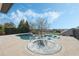 Infinity pool and spa with lounge chairs and black iron fence against blue sky backdrop at 4959 Tennessee Lake Dr, Auburndale, FL 33823