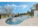 Backyard infinity pool with connected hot tub and lounge chairs with a view at 4959 Tennessee Lake Dr, Auburndale, FL 33823