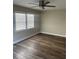 Spacious bedroom with a ceiling fan, wood-look floors, and natural light creating a serene and inviting atmosphere at 521 Tennessee Ave, St Cloud, FL 34769