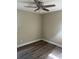 This cozy bedroom features a ceiling fan and wood-look laminate flooring at 521 Tennessee Ave, St Cloud, FL 34769