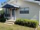 Inviting single-story home featuring a covered porch, neat landscaping, and a welcoming front entrance at 521 Tennessee Ave, St Cloud, FL 34769