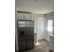 Contemporary kitchen featuring stainless steel refrigerator, white cabinets, and stylish countertops at 521 Tennessee Ave, St Cloud, FL 34769