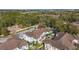 Scenic aerial shot of townhomes surrounded by lush trees, with parking and partial skyline views at 5360 Diplomat Ct # 107, Kissimmee, FL 34746