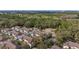 Aerial view of a community of townhomes near a golf course and wooded areas in a suburban setting at 5360 Diplomat Ct # 107, Kissimmee, FL 34746