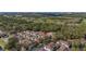 Aerial view of townhomes in a wooded area near a golf course, showcasing community layout and landscaping at 5360 Diplomat Ct # 107, Kissimmee, FL 34746