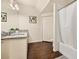 Bright bathroom featuring granite countertop, wood-look flooring and shower-tub combination at 5360 Diplomat Ct # 107, Kissimmee, FL 34746