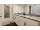 Bathroom featuring double vanity with granite counters, hardwood flooring, and plenty of light at 5360 Diplomat Ct # 107, Kissimmee, FL 34746