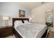 Bedroom featuring a queen sized bed, carpet flooring, and bedside table lamps at 5360 Diplomat Ct # 107, Kissimmee, FL 34746
