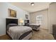 Bright bedroom with carpet flooring and twin beds, each with bedside lamps at 5360 Diplomat Ct # 107, Kissimmee, FL 34746