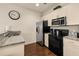 Bright kitchen featuring stainless steel appliances, granite counters, and tiled backsplash at 5360 Diplomat Ct # 107, Kissimmee, FL 34746