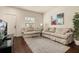 Comfortable living room featuring neutral colored couches and a TV stand at 5360 Diplomat Ct # 107, Kissimmee, FL 34746