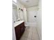 Clean bathroom with vanity, tiled floors, shower with tub, and modern fixtures at 5674 Sycamore Canyon Dr, Kissimmee, FL 34758