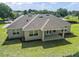 Exterior shot of a home featuring a covered patio, well-kept lawn, and windows for natural light at 5701 Crestview Dr, Lady Lake, FL 32159