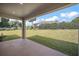 View of the backyard showing the lush green lawn and privacy landscaping at 5701 Crestview Dr, Lady Lake, FL 32159