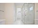 Bright bathroom featuring a glass enclosed shower and marble floors at 5701 Crestview Dr, Lady Lake, FL 32159