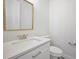 Elegant half bathroom with a vanity, modern fixtures, and a coordinating decorative mirror at 5701 Crestview Dr, Lady Lake, FL 32159