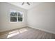 Well-lit bedroom with a large window, neutral walls, and light wood-look flooring at 5701 Crestview Dr, Lady Lake, FL 32159